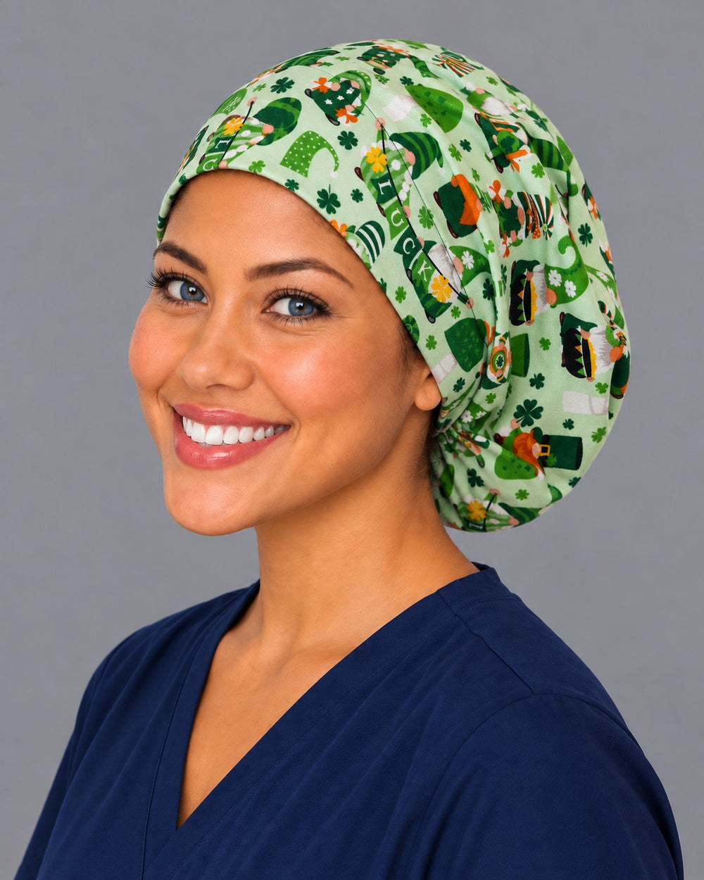 Gnome green Euro scrub cap, right angled smiling view — mushroom and shamrock print favorite every March