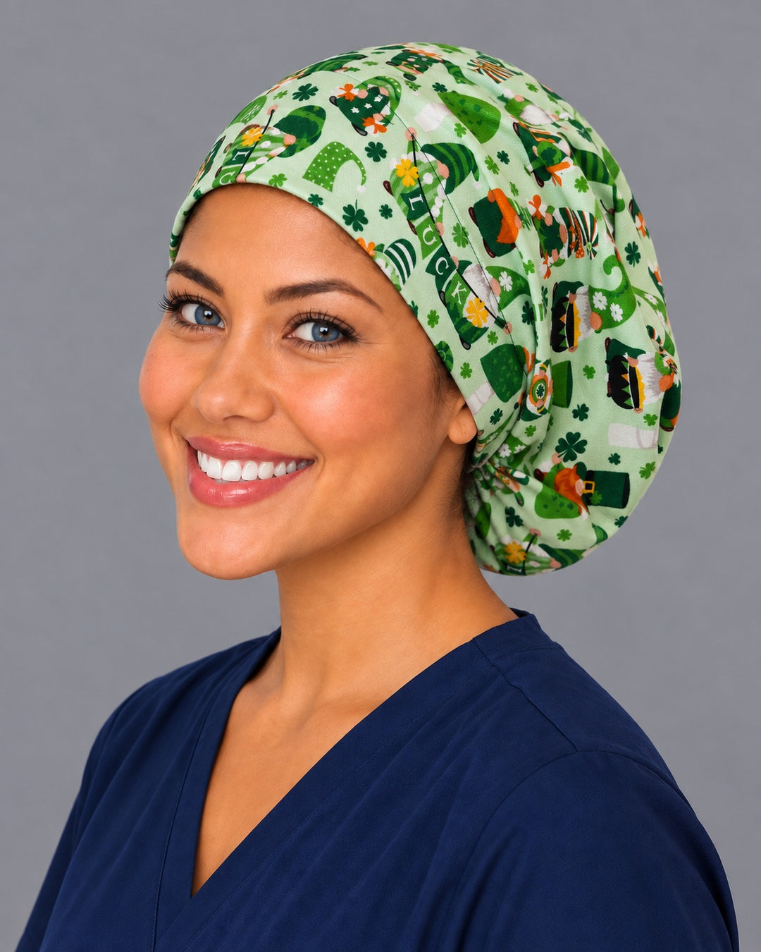 Gnome green Euro scrub cap, right angled smiling view — mushroom and shamrock print favorite every March