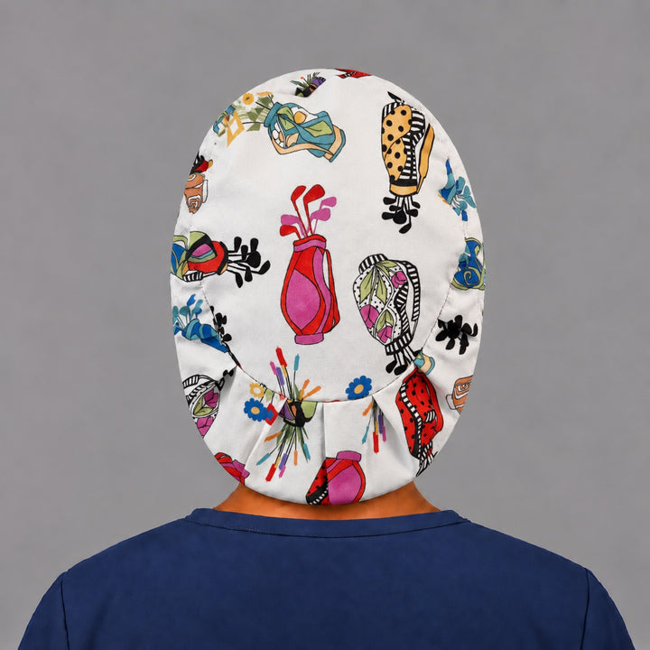 Back view of the golf bags and blossoms Euro scrub cap — elastic gathered back showing golf bags across the white crown