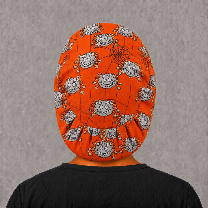 Left side profile of the googly spider Euro surgical hat — cartoon spiders and spiderweb print, breathable cotton cap for nurses