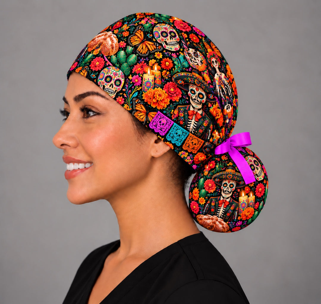 Left profile of a ponytail gorro quirúrgico with a charro calavera, pan de muerto and papel picado on the bun pouch