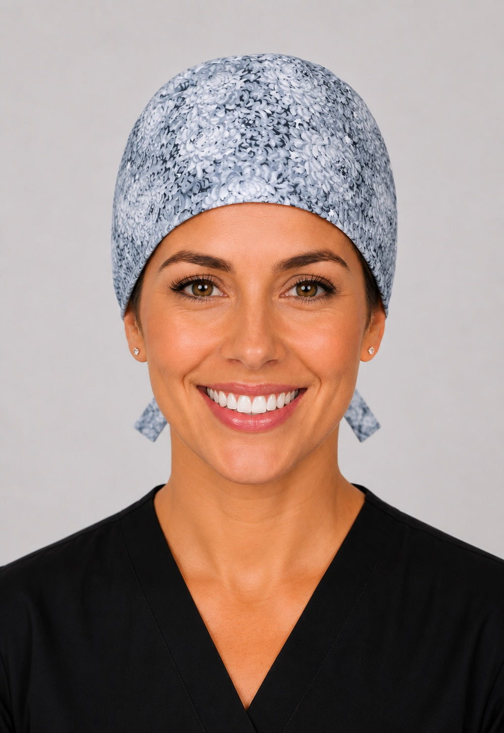 Light gray floral scrub cap for short hair, handmade neutral flower print tie-back surgical hat on OR nurse, front view