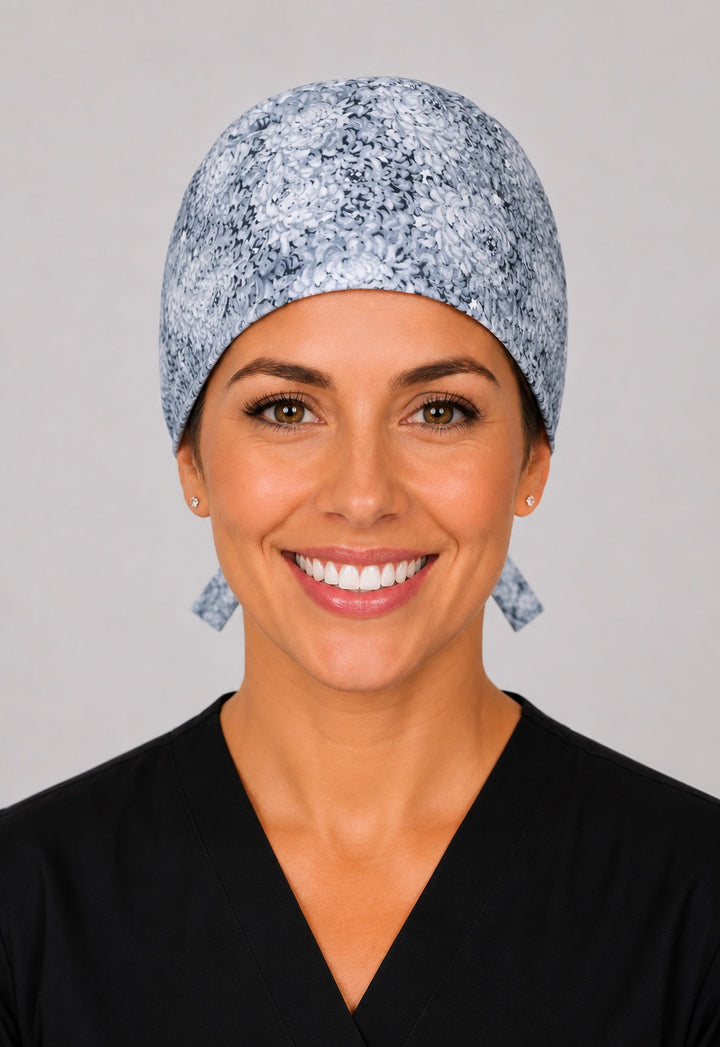 Light gray floral scrub cap for short hair, handmade neutral flower print tie-back surgical hat on OR nurse, front view