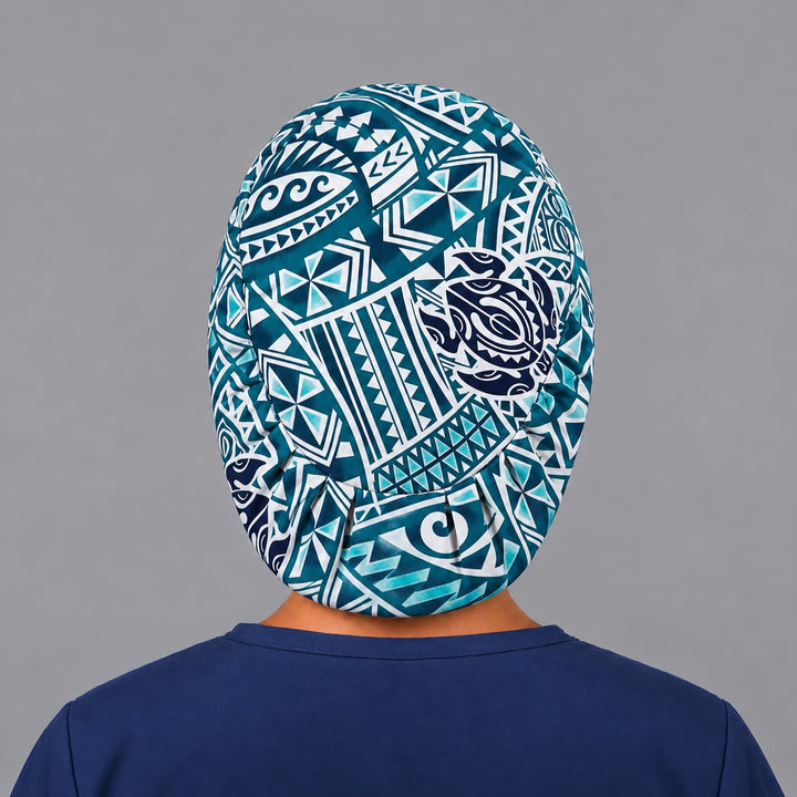 Back view of the Guardian of the Reef Euro scrub cap — elastic gathered back showing tribal spirals and turtles across the crown