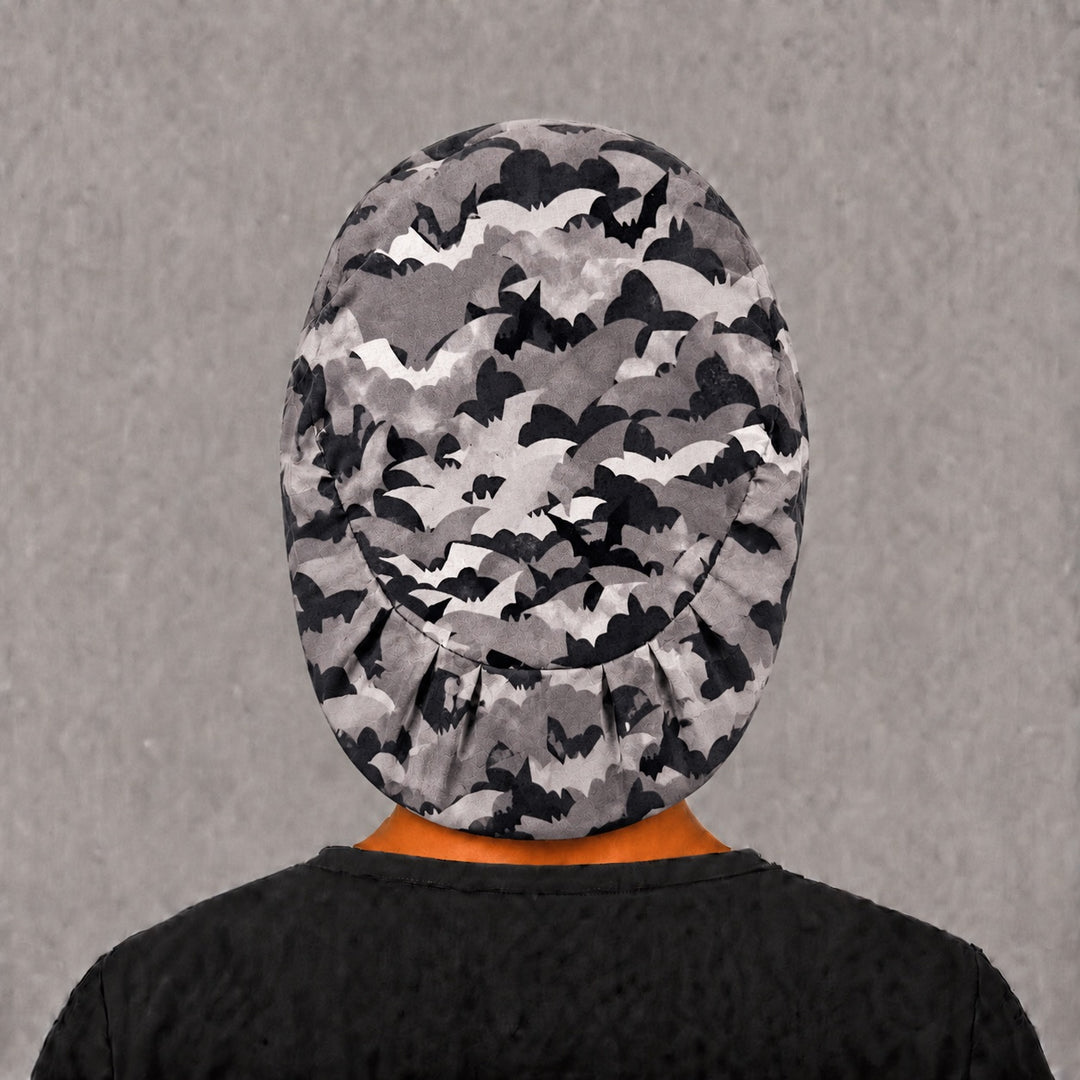 Back view of the Halloween bat Euro scrub cap — elastic gathered back showing bats in flight across the grey crown