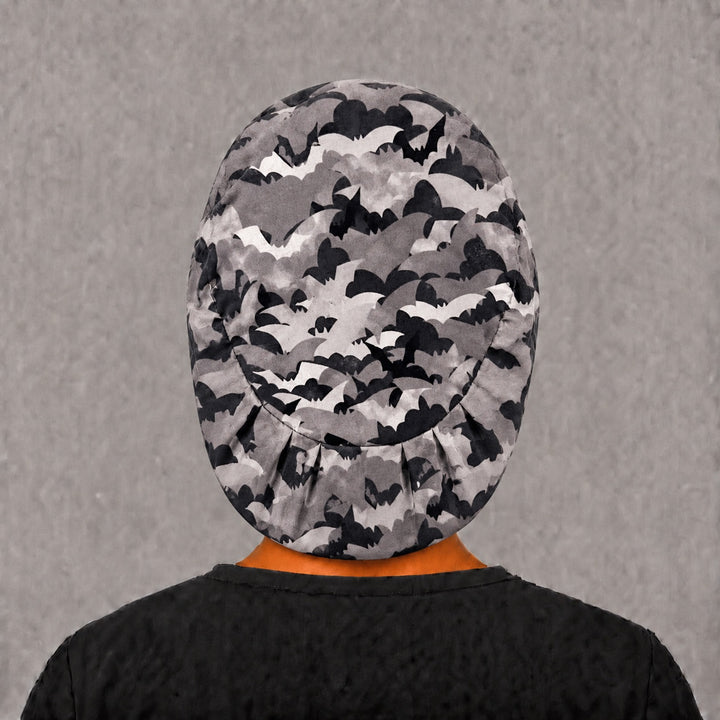 Back view of the Halloween bat Euro scrub cap — elastic gathered back showing bats in flight across the grey crown