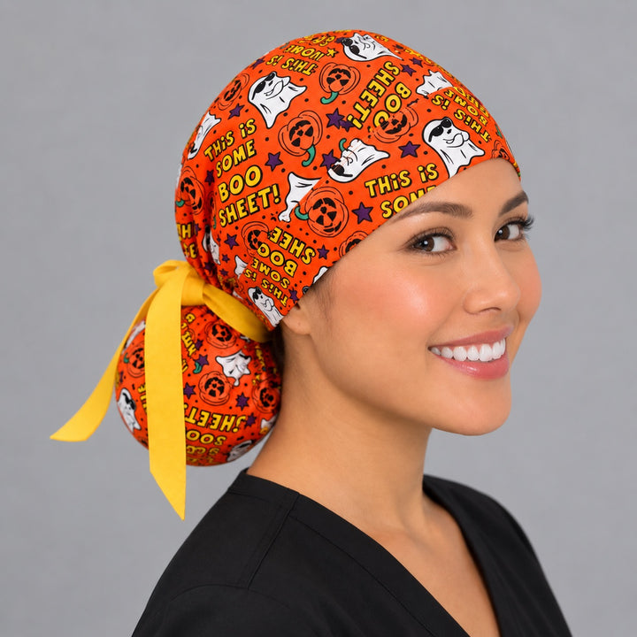 Halloween Boo Sheet ponytail cap, right angled smiling view — handmade spooky season surgical cap, USA made