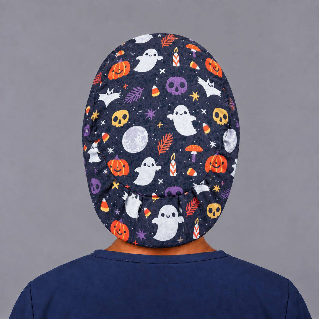 Back view of the Halloween ghost and pumpkin Euro scrub cap — elastic gathered back showing skulls and candy corn across the navy crown