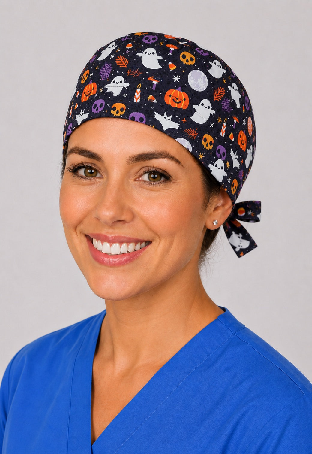 Nurse in Halloween ghost and pumpkin tie back scrub cap, front view of fall surgical hat by OR World