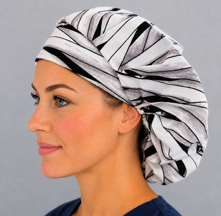 Halloween mummy bouffant scrub cap left side profile showing mummy-wrap bandage print with hidden eyes, women&