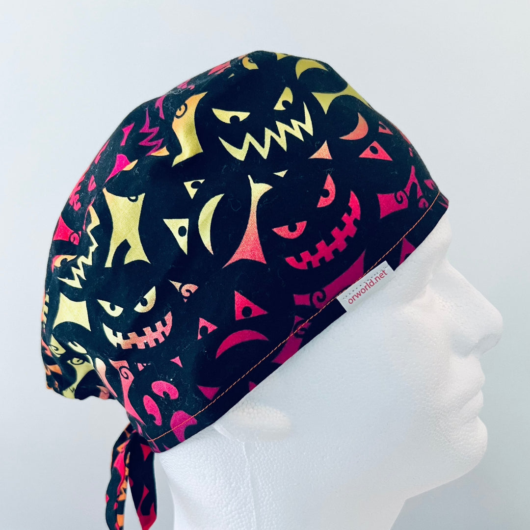 Halloween neon jack-o'-lantern faces tie-back scrub cap on a model — handmade-in-USA surgical hat from OR World.