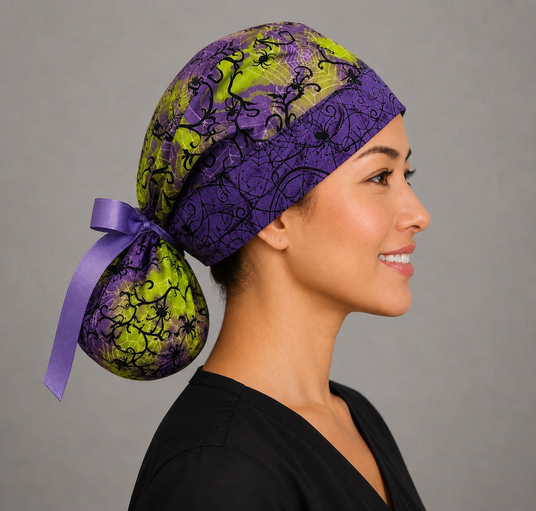 Halloween spider ponytail nurse cap front band detail showing black spiders and spider webs on purple band with lime green crown and purple ribbon