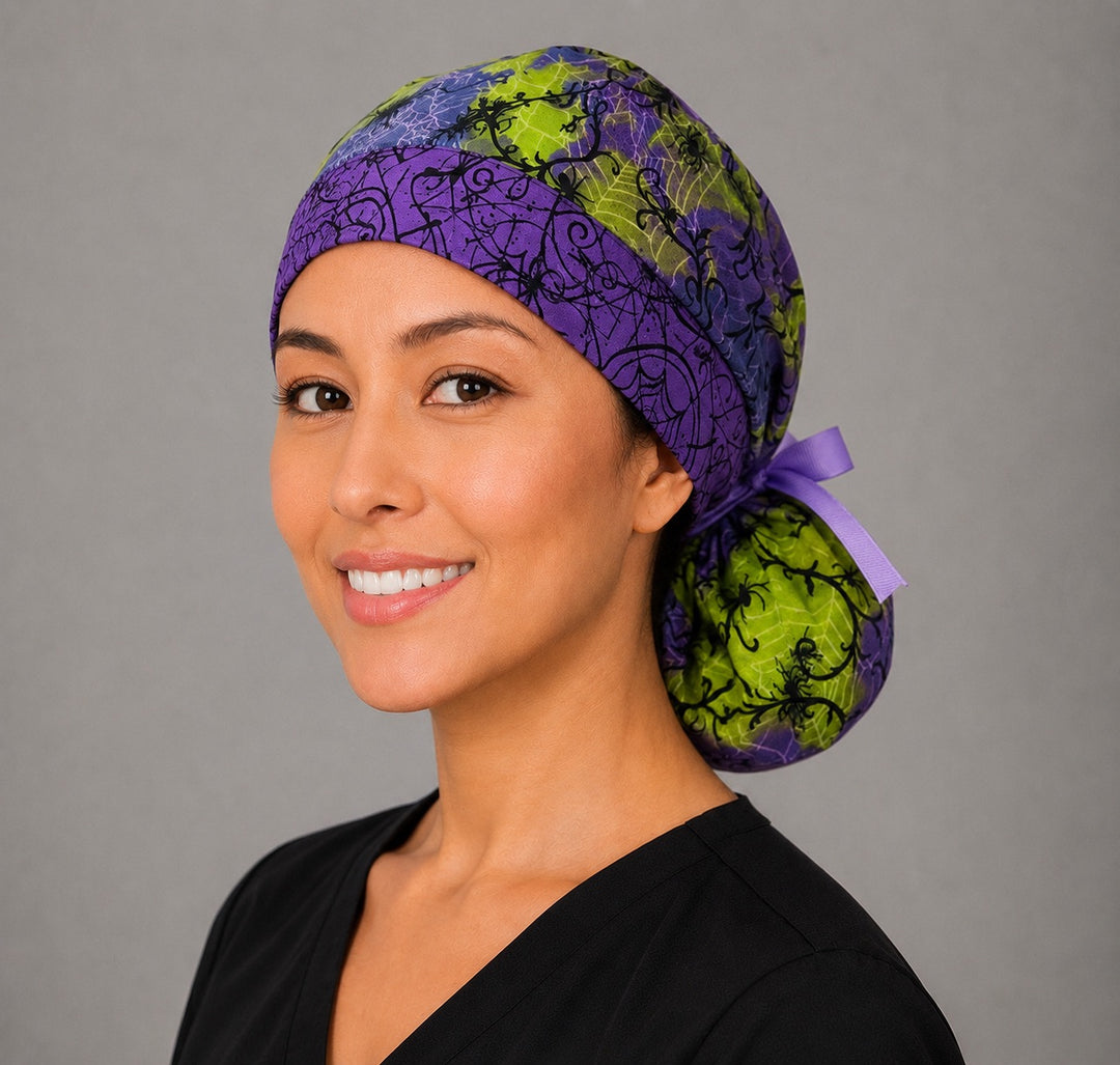 Halloween spider ponytail scrub cap left side profile with full ponytail pouch of black spiders and webs on purple and lime green with long purple ribbon ties