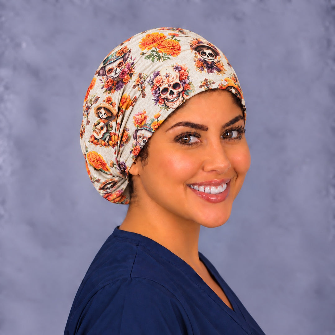 Smiling surgical tech in a handmade Mexican scrub cap, over the shoulder view of the sugar skull and mariachi calavera print, women-owned OR World