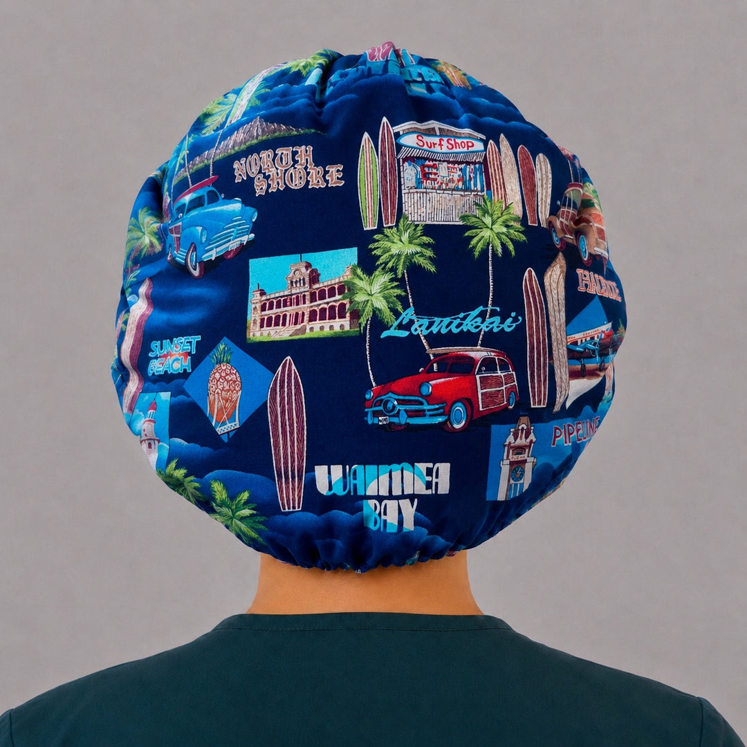 Back view of the Hawaii vacation bouffant scrub cap — Waimea Bay, Sunset Beach and surf shop scenes across the full navy crown