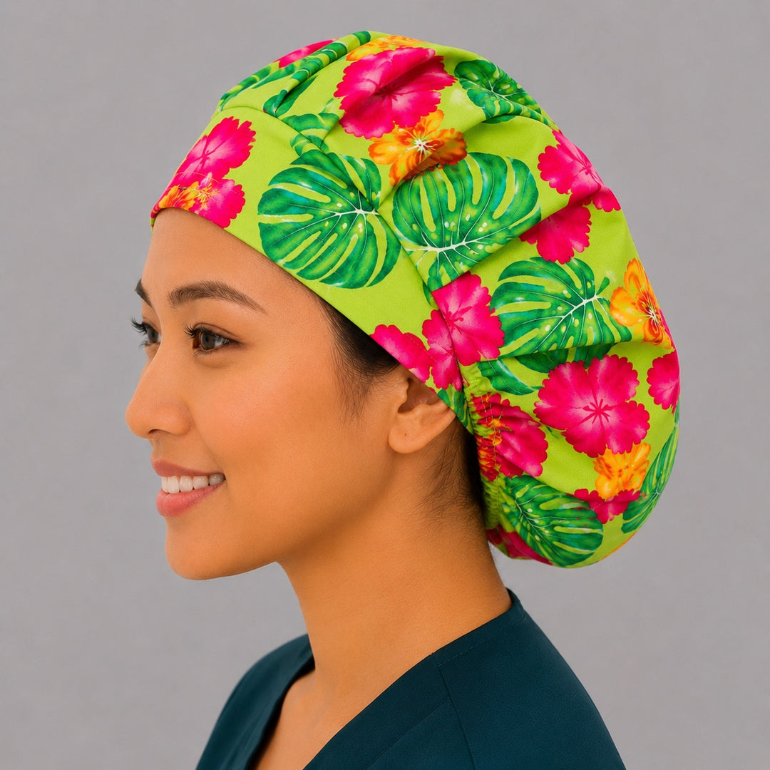 Hawaiian hibiscus bouffant scrub cap left side profile showing pink and orange hibiscus and palm leaves on lime green, women&