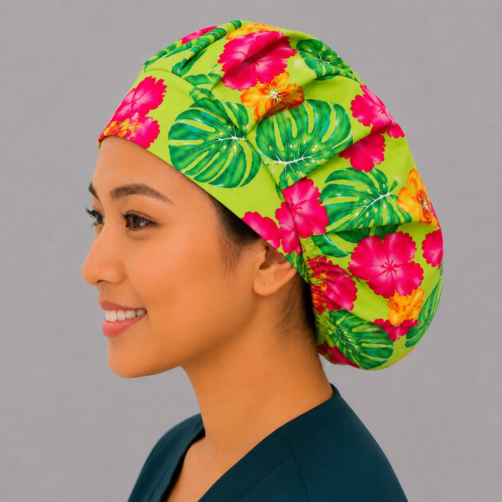 Hawaiian hibiscus bouffant scrub cap left side profile showing pink and orange hibiscus and palm leaves on lime green, women&