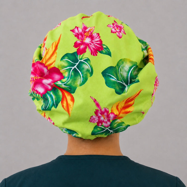 Hawaiian hibiscus bouffant surgical cap right side profile showing pink hibiscus and palm leaves on lime green, OR World tropical nurse hat
