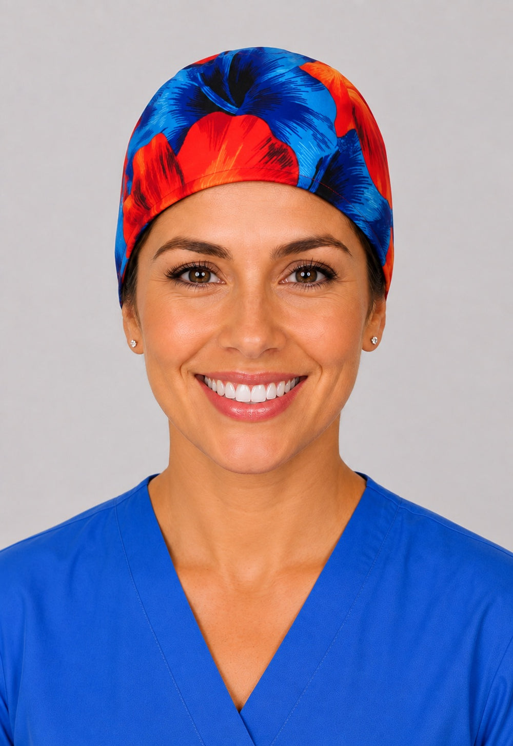 Hawaiian hibiscus scrub cap for short hair in blue and orange, handmade tropical tie-back surgical hat on OR nurse, front view