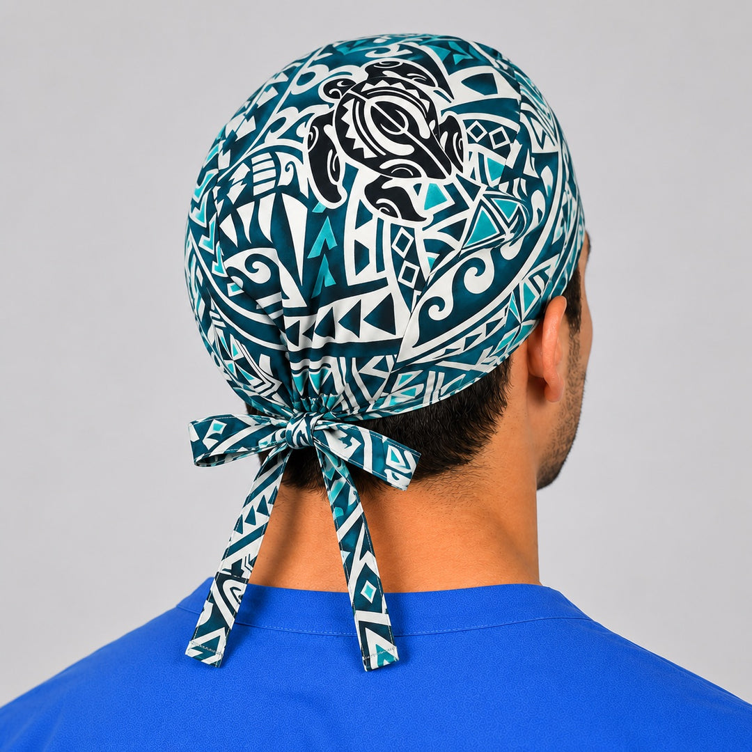 Hawaiian Honu tribal print scrub cap on a smiling male nurse, side view showing the teal turtle design and tie-back