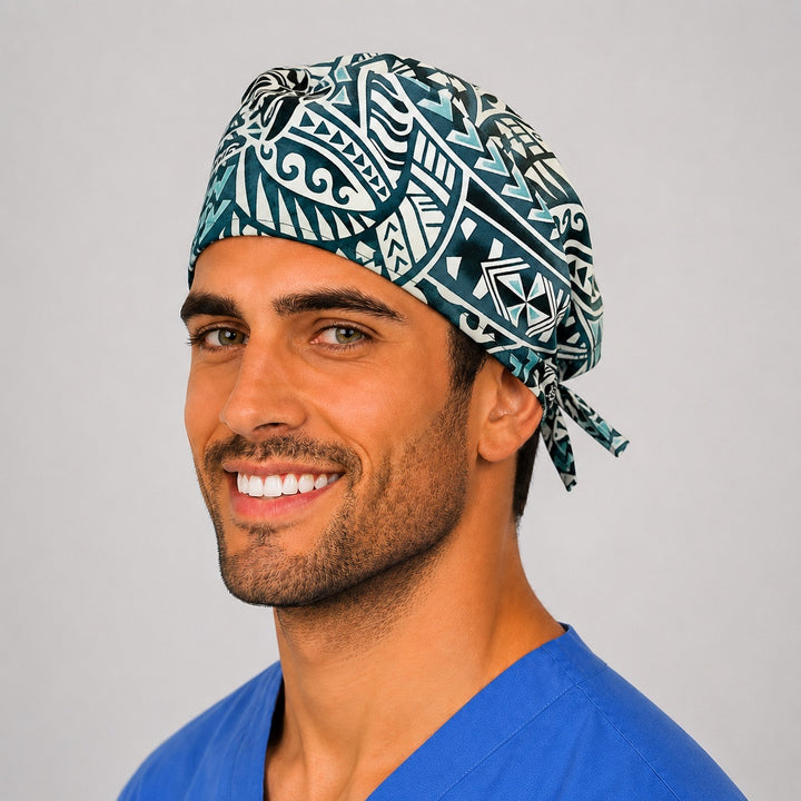Man wearing a Hawaiian sea turtle Honu tribal tie-back scrub cap in teal, navy and white, front view — OR World coastal surgical hat