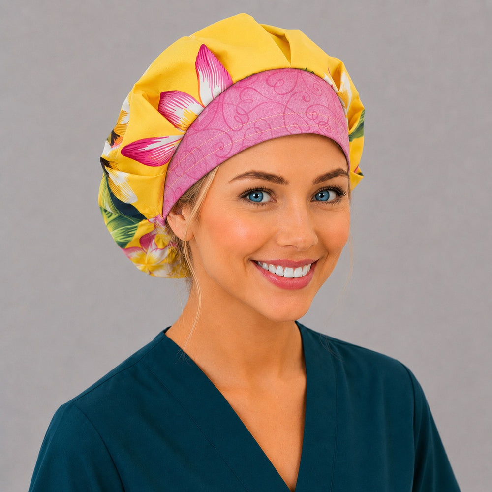 Hawaiian tropical floral bouffant scrub cap back view showing full print of yellow and pink plumeria on bright yellow, OR World tropical surgical hat