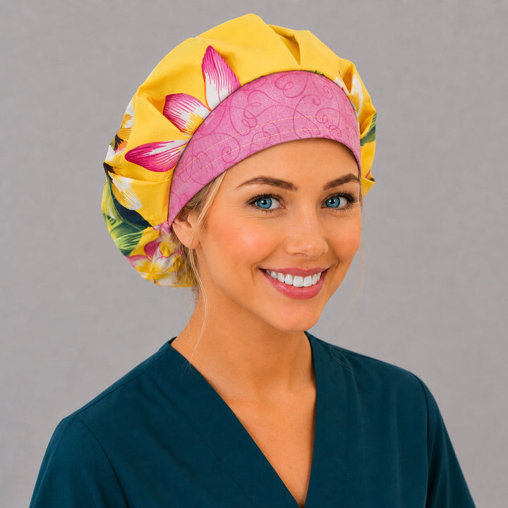Hawaiian tropical floral bouffant scrub cap back view showing full print of yellow and pink plumeria on bright yellow, OR World tropical surgical hat