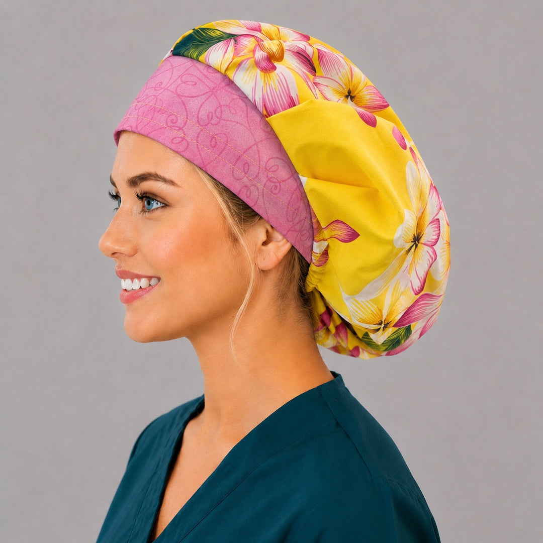 Hawaiian tropical floral bouffant surgical cap right side profile showing yellow and pink plumeria with pink swirl band, OR World tropical nurse hat