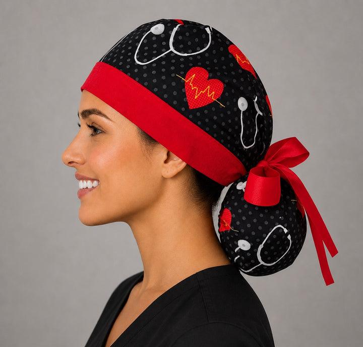 Heartbeat EKG cardiology ponytail scrub cap left side profile with full ponytail pouch of red hearts, EKG lines and stethoscopes and long red ribbon ties