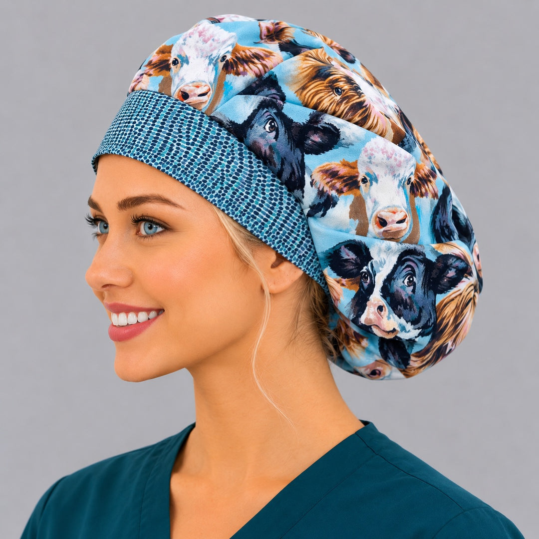 Highland cow farm animals bouffant scrub cap left three-quarter angle on smiling model showing shaggy Highland and dairy cows on sky blue with blue-dot band, women&