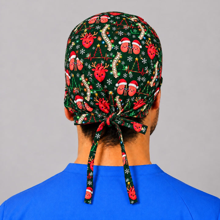 Back view of a holiday anatomy OR cap, showing full crown coverage and long printed ties knotted into a bow at the base of the neck