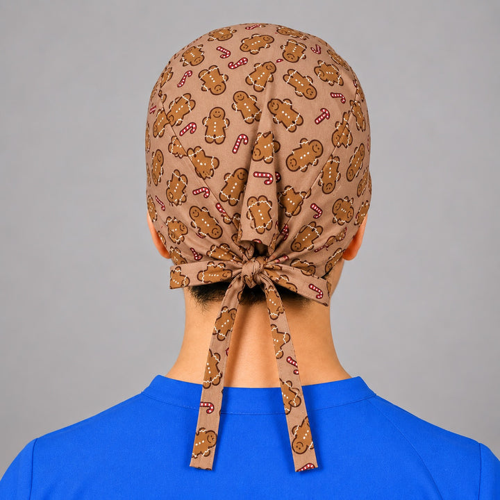 Rear knot and tie closure on holiday gingerbread scrub hat, unisex fit shown on a man from behind