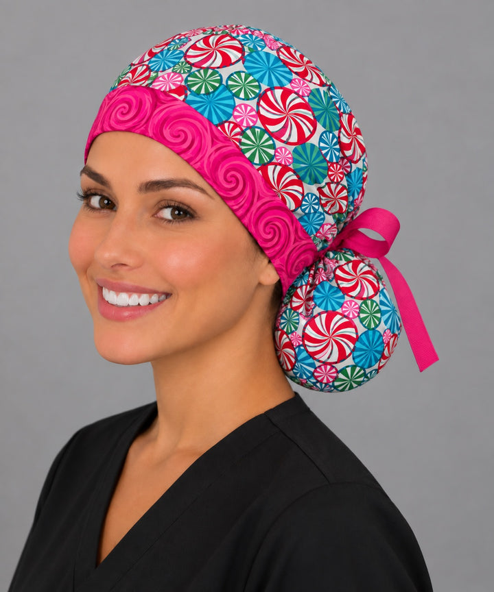 Holiday peppermint ponytail cap, left angled smiling view — festive candy print for OR nurses and surgical techs