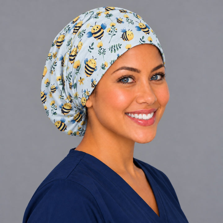 Right three-quarter angle of a honey bee nurse scrub hat, with soft folds across the crown and full back coverage over long hair