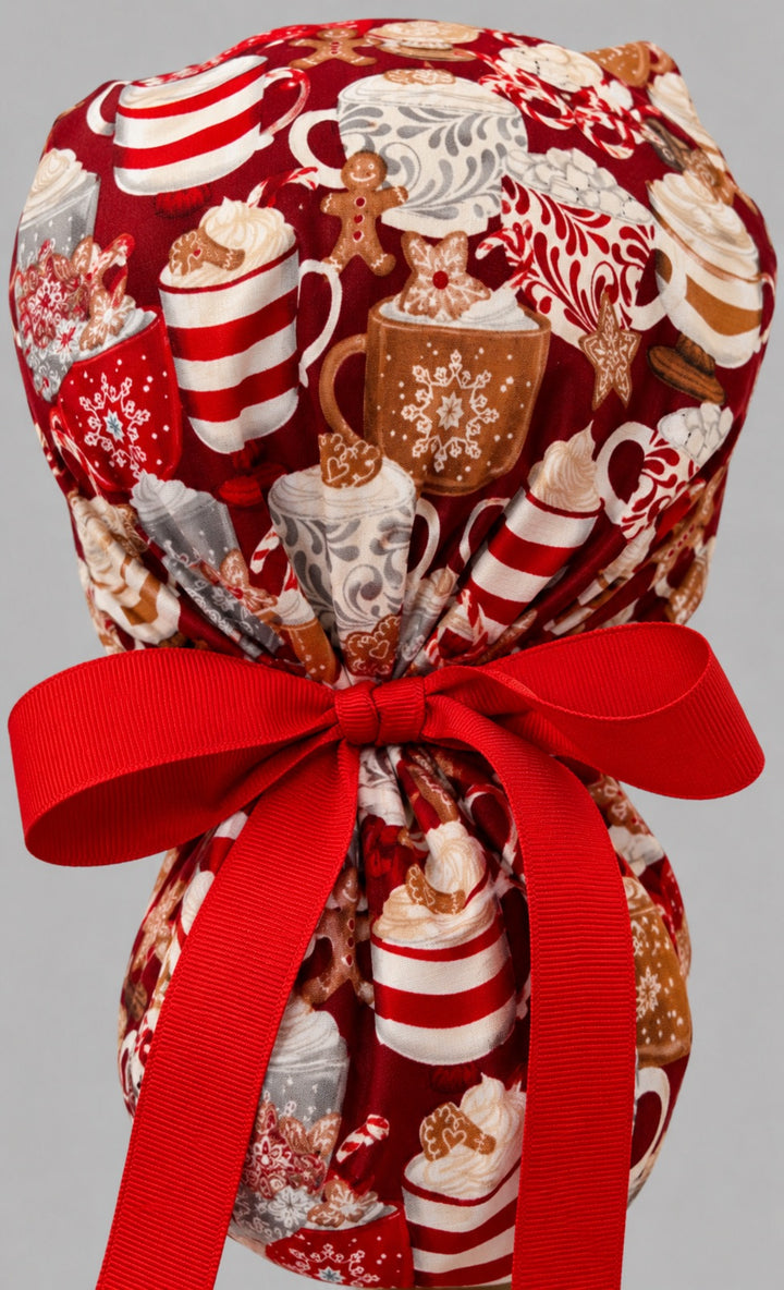 Hot chocolate ponytail nurse cap right three-quarter angle on smiling model showing cocoa, gingerbread and marshmallow print with snowman band and red ribbon bow