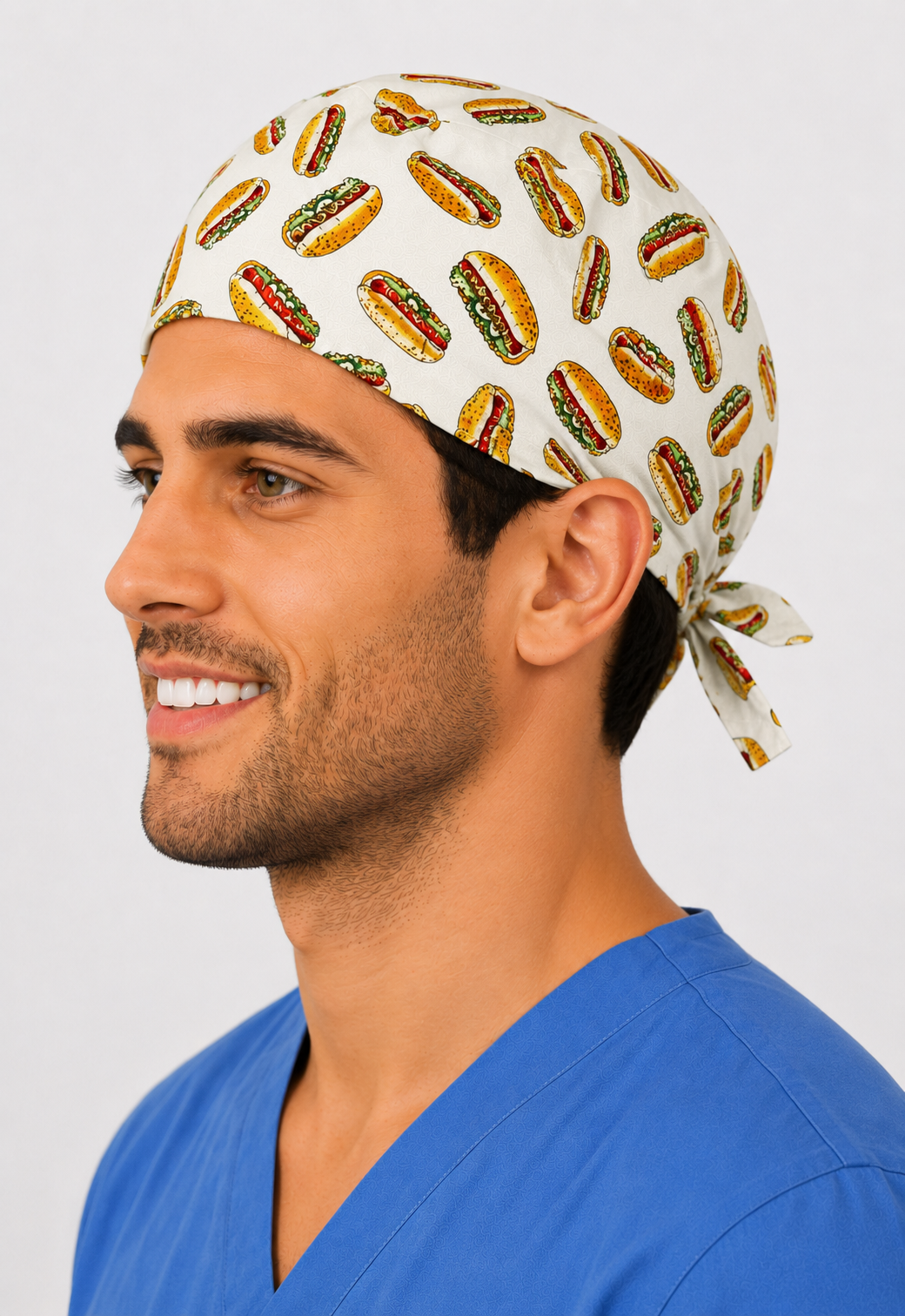 Side view of man in hot dog scrub cap with tie-back — handmade USA funny food-print surgical hat for OR nurses, surgeons &amp; techs.
