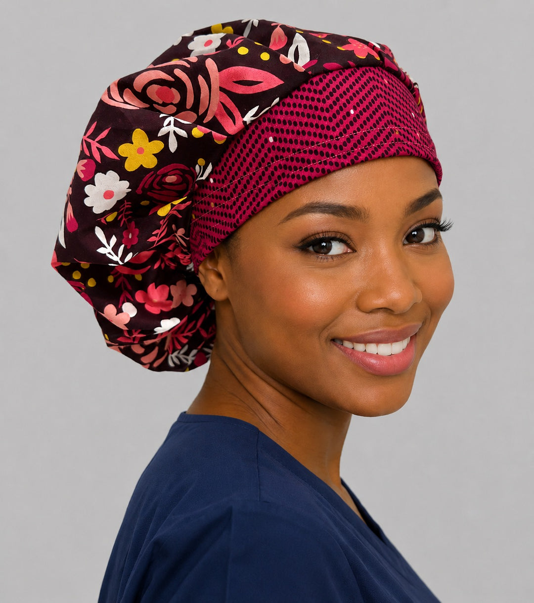 Profile view of the hot pink floral bouffant scrub cap — rose print roomy cap that secures long thick hair, great for midwives and OB nurses