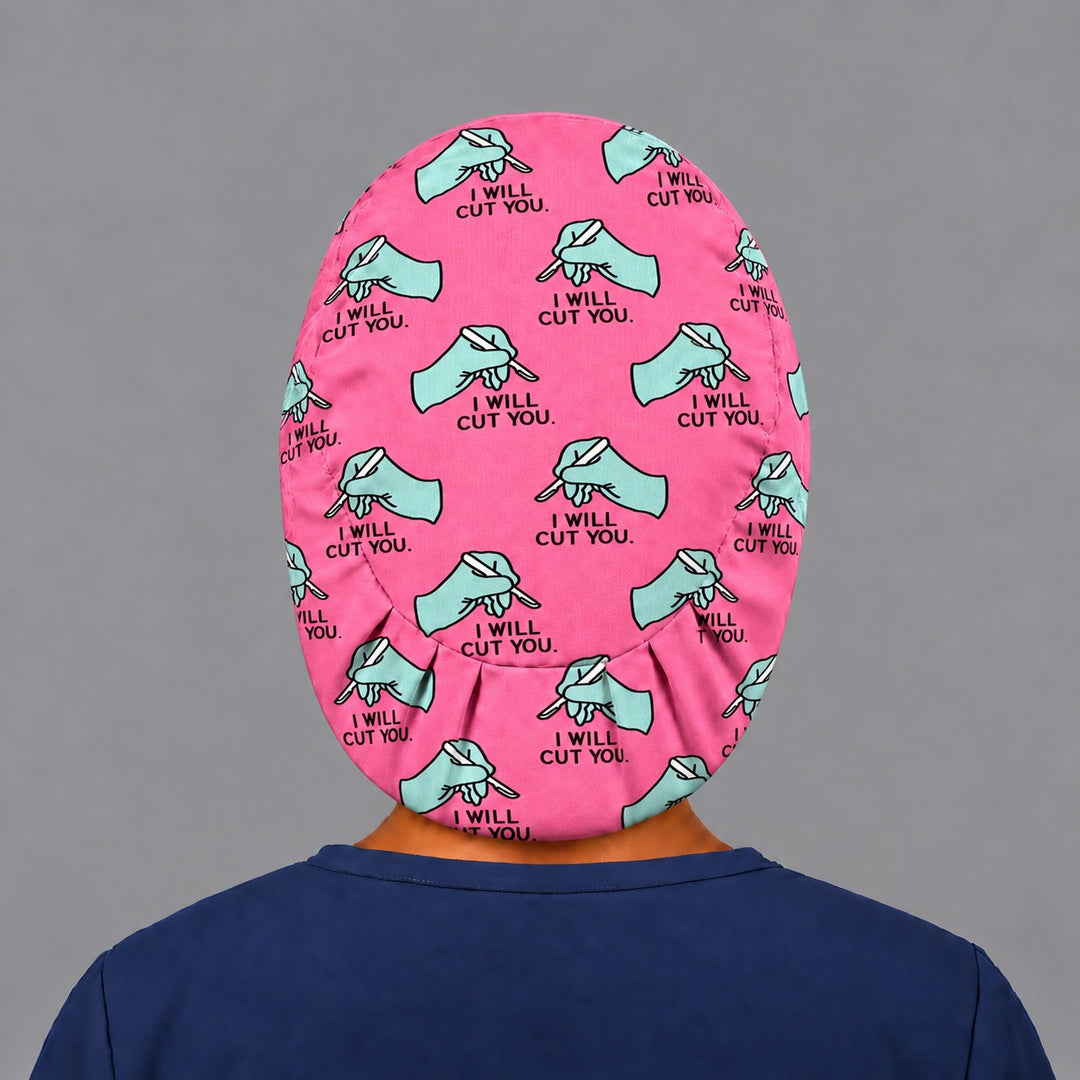 Back view of the I Will Cut You Euro scrub cap — elastic gathered back showing scalpels across the pink crown