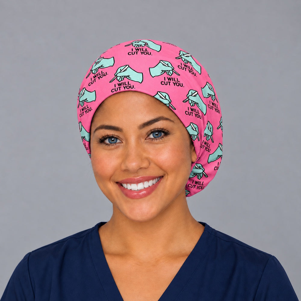 Woman wearing an I Will Cut You Euro scrub cap, front view — scalpel and glove print on hot pink, adjustable funny surgical hat