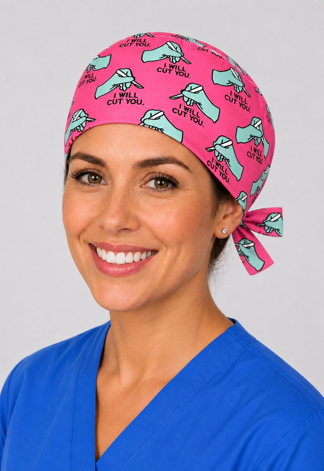 Woman with short hair wearing pink I Will Cut You funny surgery scrub cap, tie back surgical hat by OR World