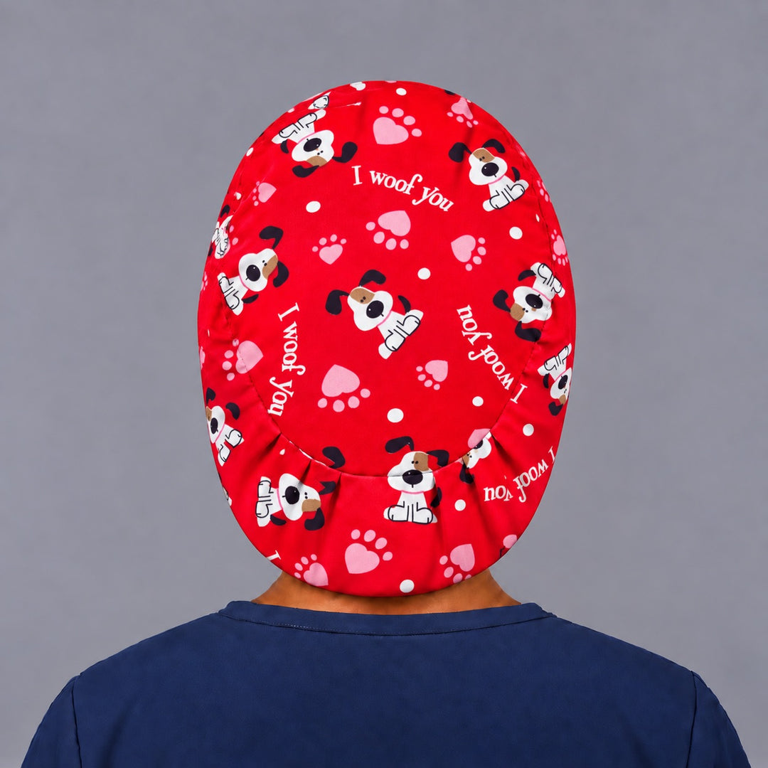 Back view of the I Woof You Euro scrub cap — elastic gathered back showing puppies and paw prints across the red crown