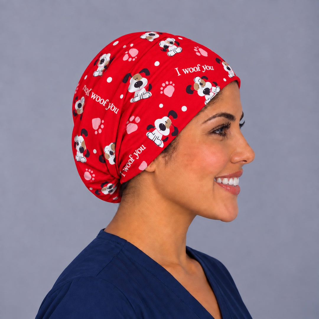 Woman wearing an I Woof You Euro scrub cap, front view — red puppy and paw print, adjustable Valentine&