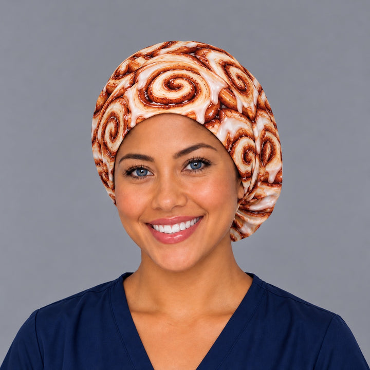 Front view of an iced cinnamon bun euro surgical hat with a smooth forehead band, a funny gift for OR nurses