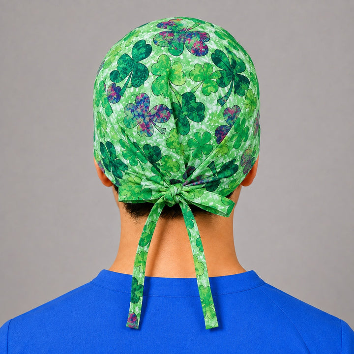 Irish charm shamrock scrub cap for short hair, handmade green watercolor clover tie-back surgical hat on OR nurse, front view