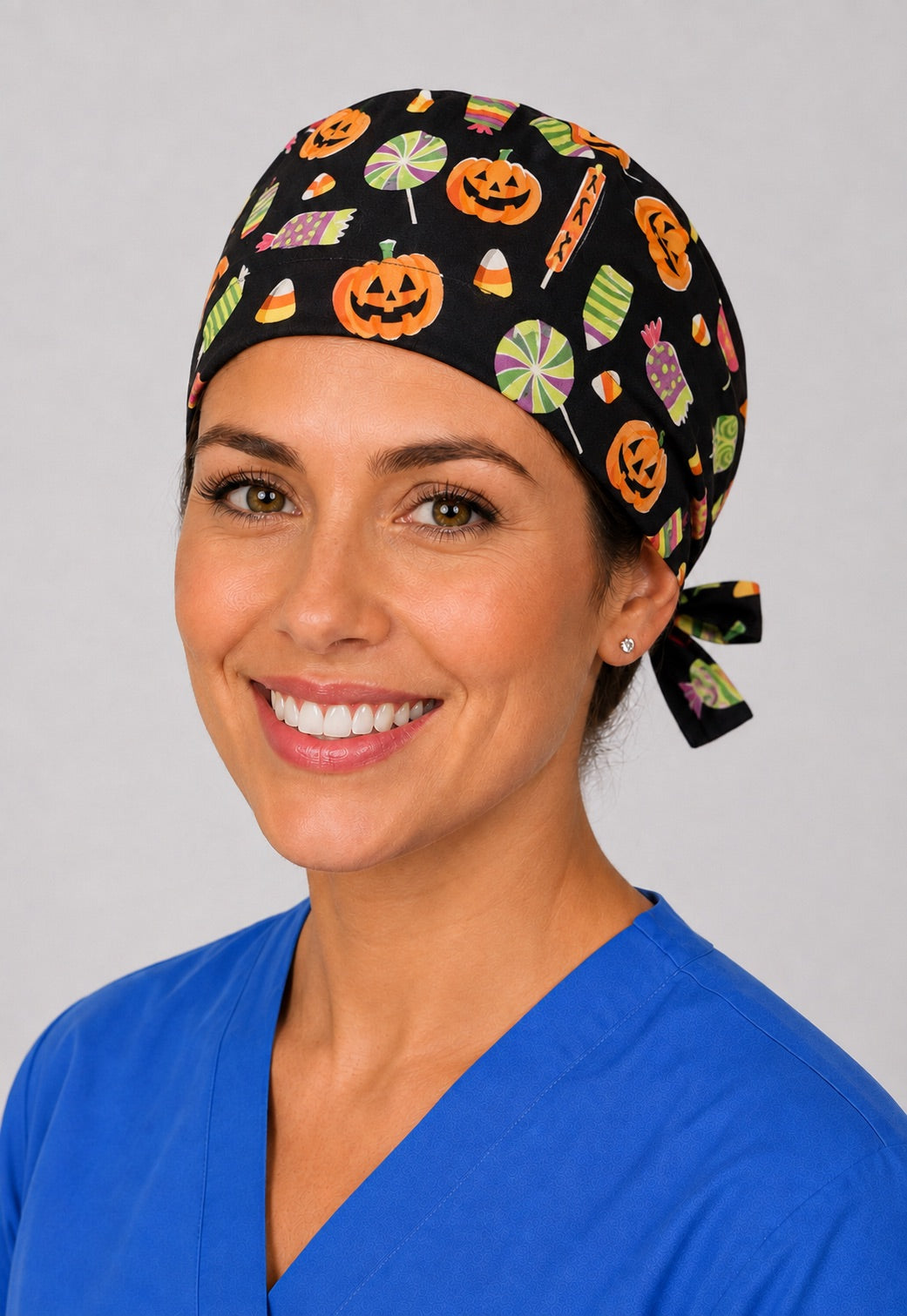 Three-quarter view of jack-o'-lantern and candy unisex black Halloween surgical hat for nurses and surgical techs