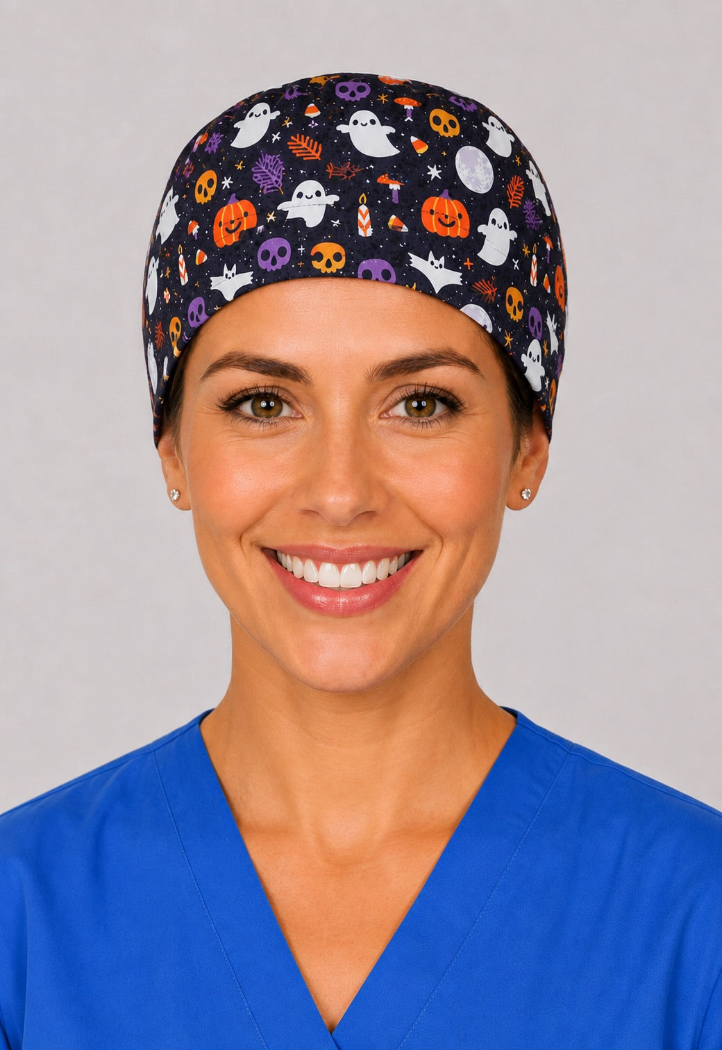 Jack o lantern, skull and bat scrub hat in three quarter view, seasonal medical cap for autumn shifts