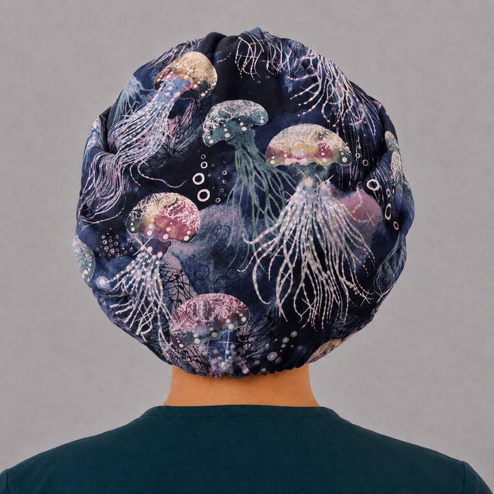 Back view of the jellyfish bouffant scrub cap — full gathered coverage showing jellyfish and tentacles across the navy crown