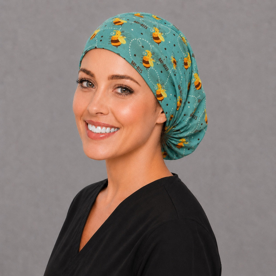Labor and delivery bee Euro scrub cap, right angled smiling view — cute pacifier bee print for midwives and mother-baby teams