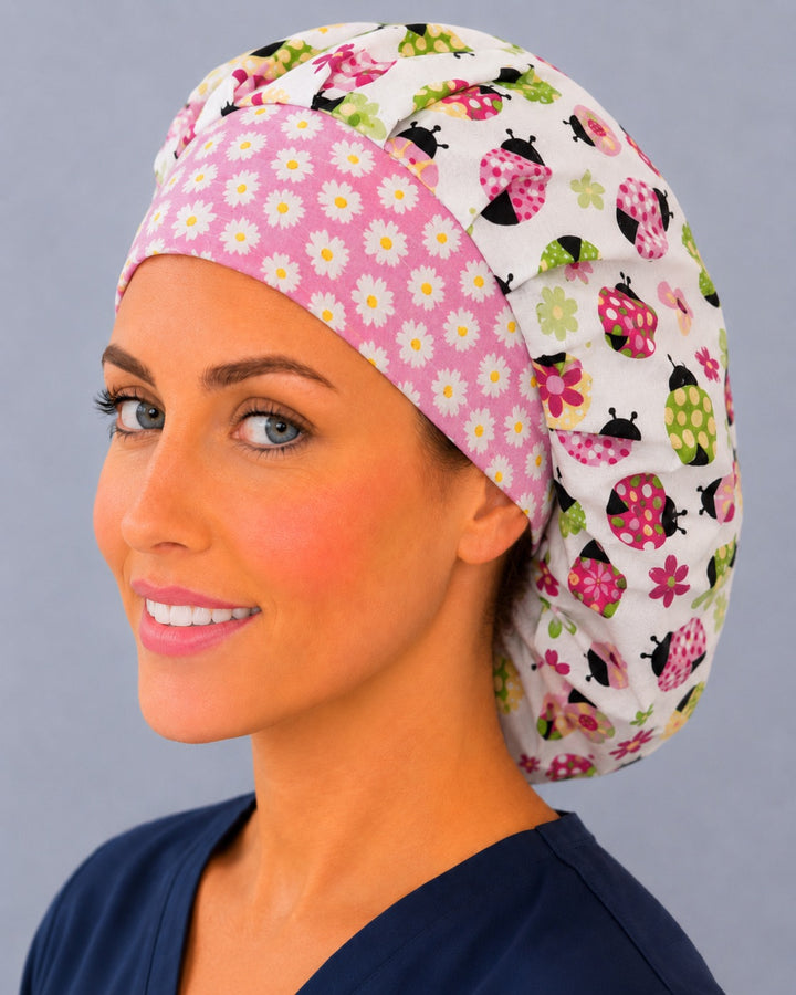Back view of the ladybug bouffant scrub cap — full roomy fit showing pink, green and yellow ladybugs with daisies on cream