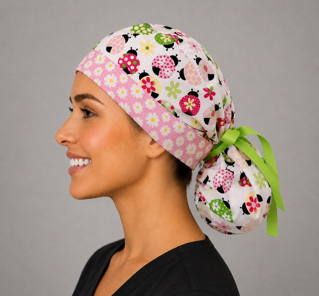 Ladybug daisy ponytail scrub cap right side profile showing gathered pouch of floral ladybugs and daisies on white with long green ribbon ties